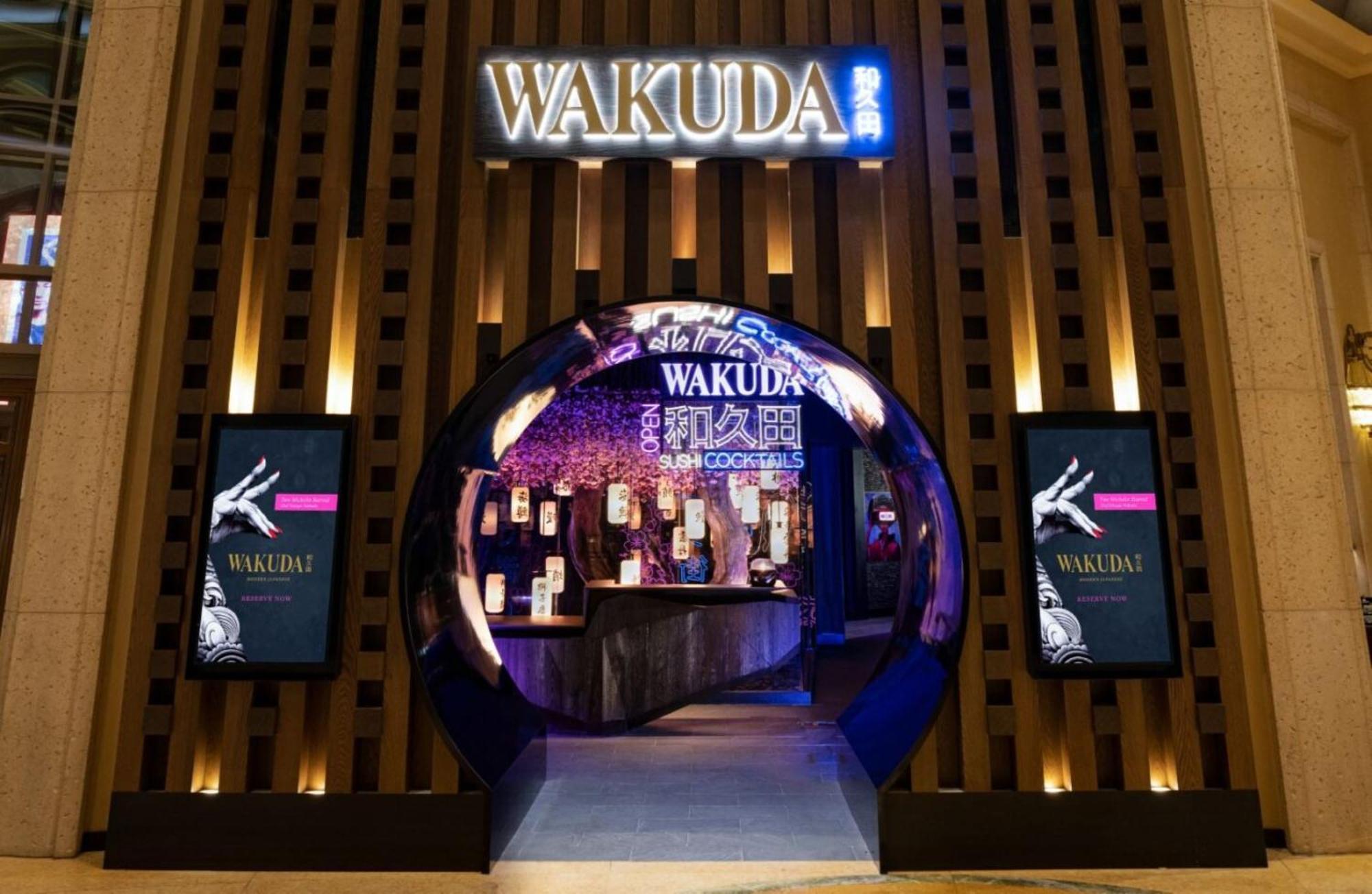 The Palazzo At The Venetian Hotel Las Vegas Exterior photo The photo showcases the entrance of a restaurant named "Wakuda." The design features a circular archway that leads into the establishment. The entrance is elegantly illuminated, with a blend of warm and cool lighting that highlights the restaurant's 